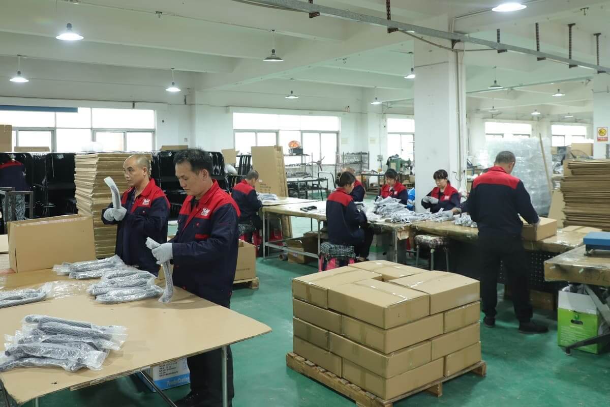 Workers inspect and pack finished metal hardware parts at Yizhijie factory packaging workshop
