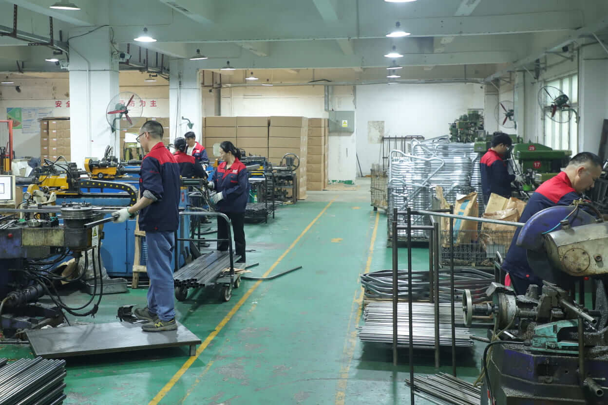 Workers operate tube bending machines and drill presses in Yizhijie metal hardware production workshop